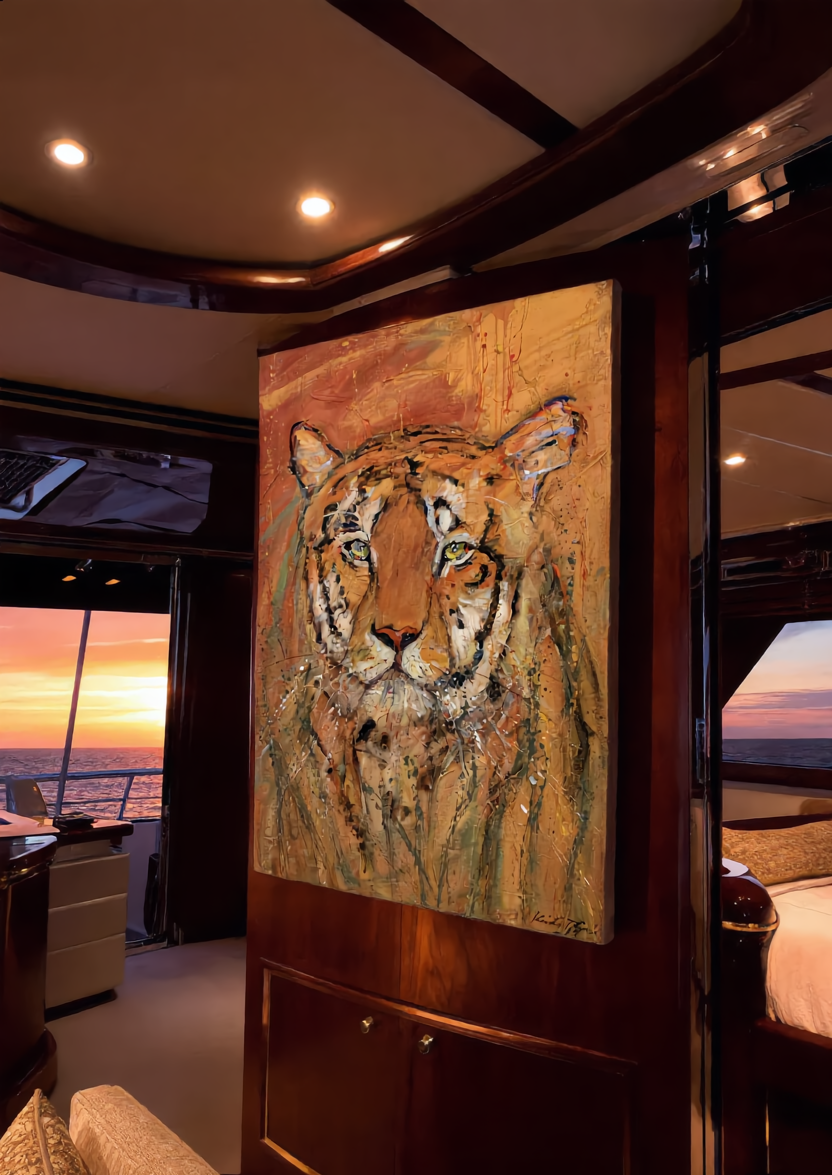 The Tiger premium canvas wall art by Swiss artist Heidi Thöni displayed inside a luxury yacht cabin with ocean sunset view